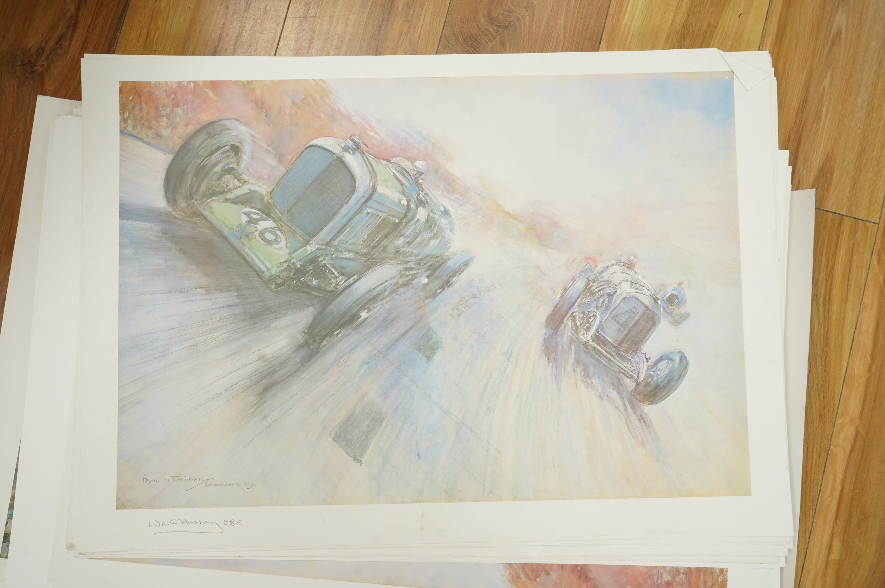 Two framed and signed motor racing lithographs by Anthony Heal and Walter Hassan of Le Mans and Brookslands racing scenes, the largest frame 61.5 x 76cm, together with a folio containing a large number of unframed simila